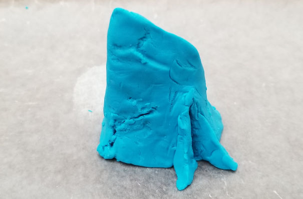Rough three dimensional sculpt of Aqualith mark made out of Playdoh
